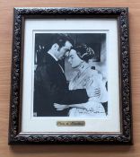 Olivia De Havilland signed and framed black and white photo. Measures 12"x14" appx. Good