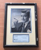 George Clooney signed mounted and framed cheque with black and white photo above. Measures 18"x13"