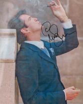 Pierce Brosnan OBE signed colour photo 10x8 Inch 'smoking a Cigar Estil James Bond'. Actor and