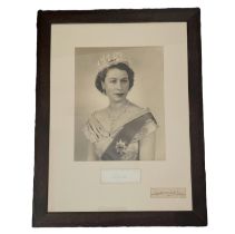 Queen Elizabeth II signature piece and Dorothy Wilding signature piece mounted below black and white