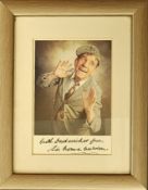 Sir Norman Wisdom signed colour photo. Mounted and framed to approx. size 8x6inch. Good condition.