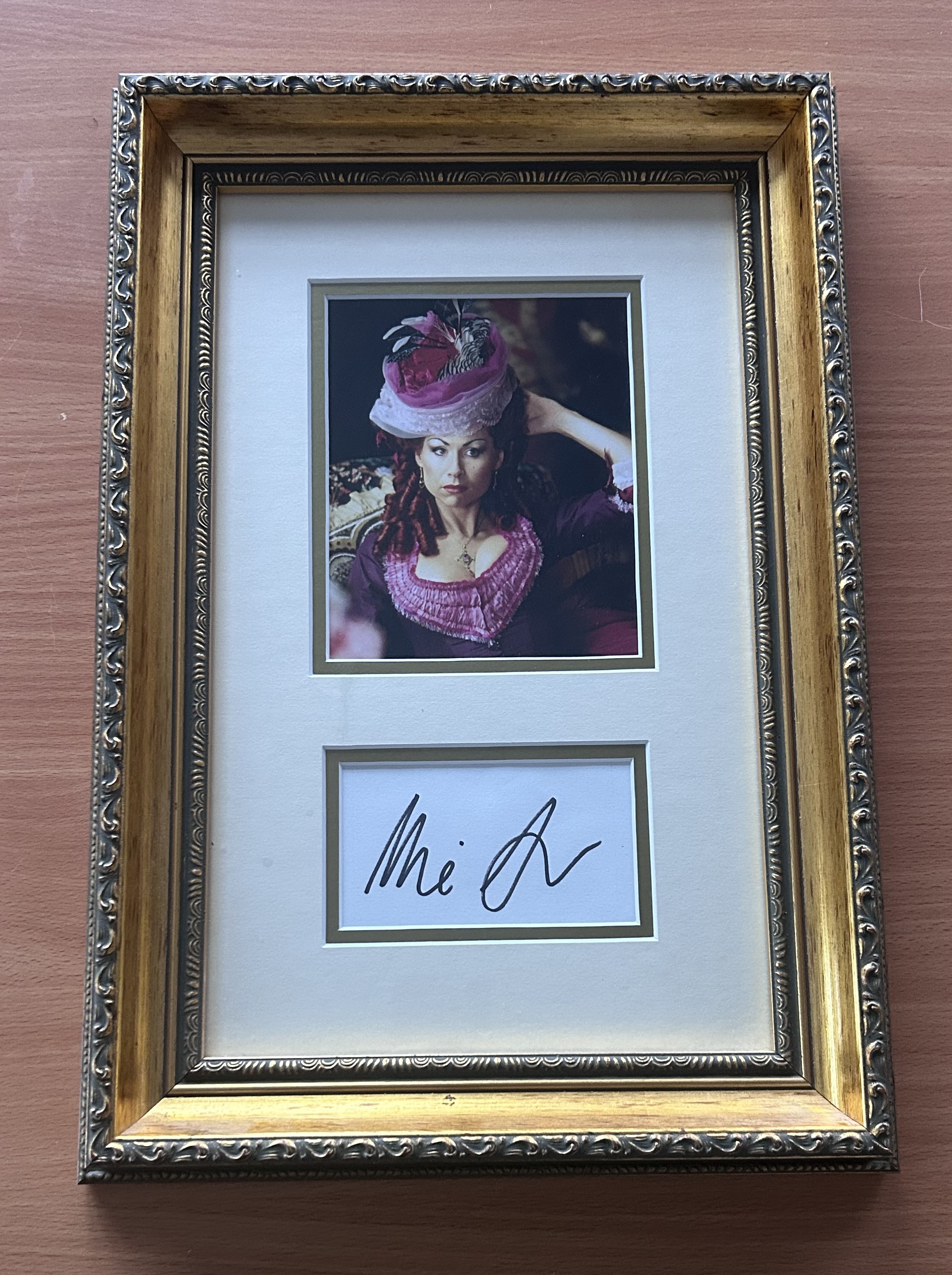 Minnie Driver signed mounted and framed colour photo with signature below. Measures 17"x12" appx.