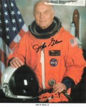 Astronaut John Glenn signed 10 x 8 orange space suit photo. Top border has been trimmed. American