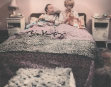 George and Mildred Brian Murphy signed 10 x 8 colour amusing bedroom scene photo. Good condition.