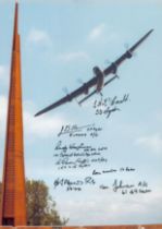 A Lancaster Flying Over the Spire Memorial, Colour Photo Signed by 7 including H J Flowers, E A
