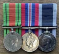 A Group of three Medals includes George IVs The Defence Medal, GEORGIVS War Medal of lion 1939-1945,