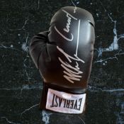 Mike Tyson and Lennox Lewis signed black Everlast boxing glove. Good condition. All autographs