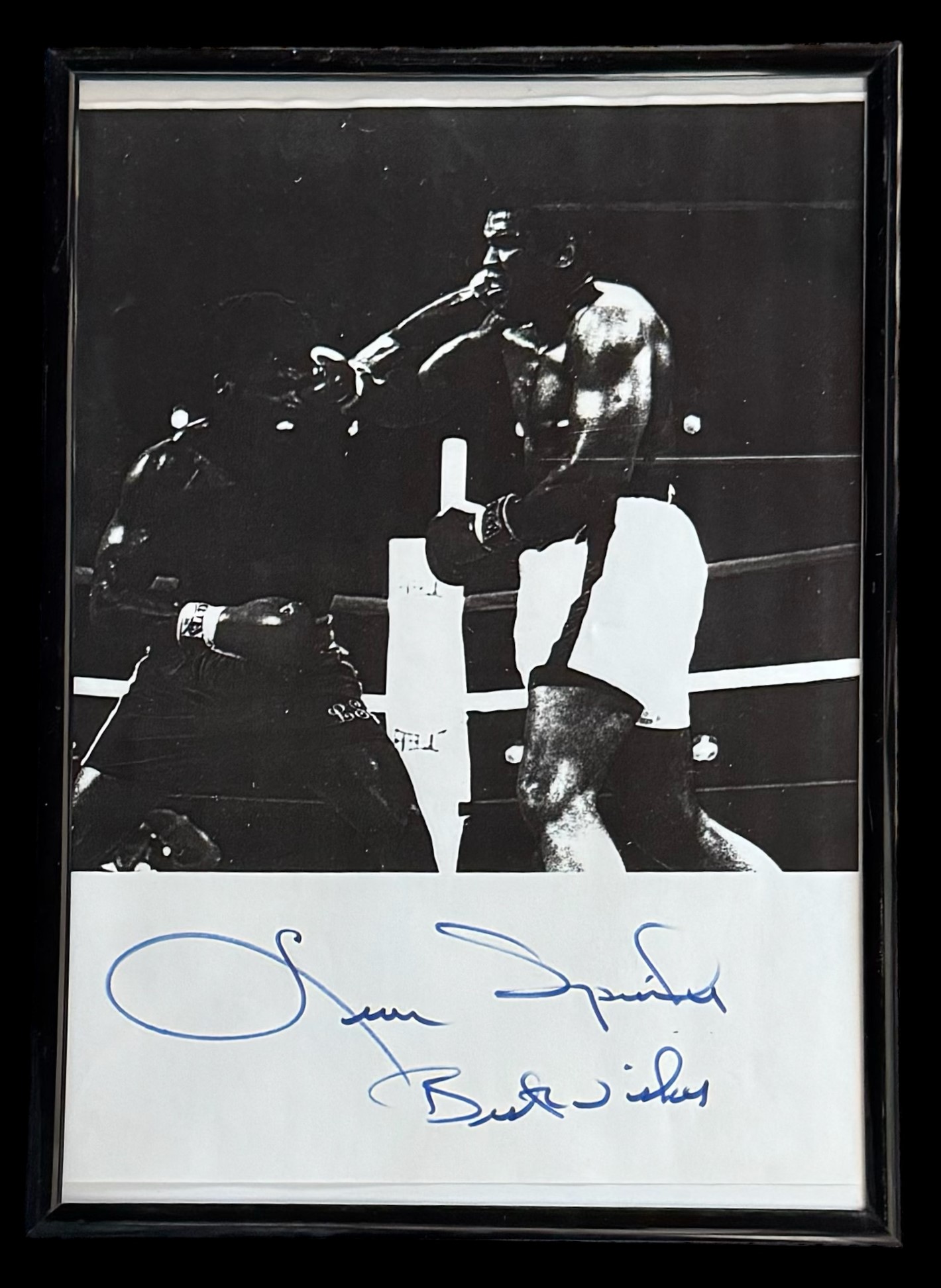 Leon Spinks signature below grainy black and white photo. Framed to approx size 12x10inch. Good