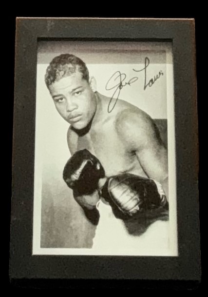 Joe Louis signed vintage photo. Framed to approx 6x4inch. Good condition. All autographs come with a