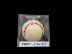 Rocky Graziano signed baseball in display case., was an American professional boxer and actor who