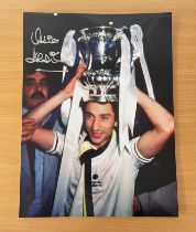 Football. Ossie Ardiles Signed 16x12 colour photo. Photo shows Ardiles with a trophy on his head.