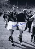 Autographed BERT TRAUTMANN 16 x 12 Photo : B/W, depicting Manchester City's Bill Leivers helping a