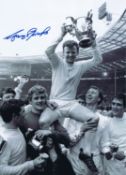 Autographed GARY SPRAKE 16 x 12 Photo : B/W, depicting Leeds United captain Billy Bremner holding