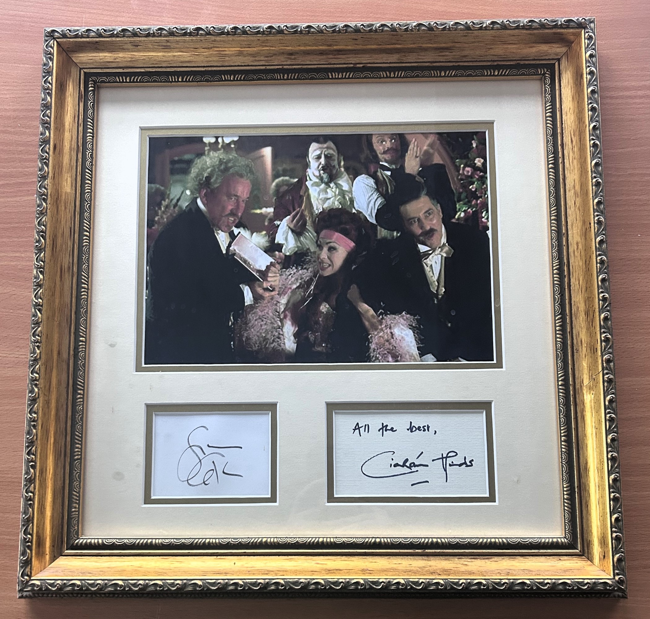 Simon Callow and Ciaran Hinds signed mounted and framed Phantom of The Opera. Measures 18"x18" appx.