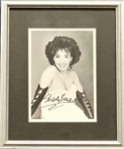 Shirley Bassey Signed black and white photo, housed in a silver effect frame measuring 11 x 9 inches