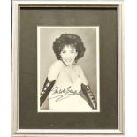 Shirley Bassey Signed black and white photo, housed in a silver effect frame measuring 11 x 9 inches