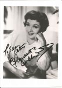 Claudette Colbert signed 7x5 inch black and white photo dedicated. Good Condition. All autographs