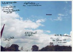 Alongside the Spire Memorial looking up at A Lancaster, Colour Photo Signed by 8 including Coby