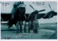 A crew in discussion stood close to a Lancaster, Black and White Photo, Signed by 5 including Eric