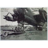 A Lancaster on the ground being loaded with Bombs, Black and White Photo, Signed by 6 including
