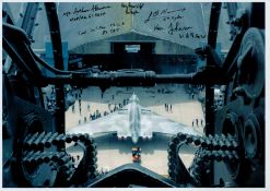 Looking out of a gun turret at a Vulcan in front of a Hanger, Colour Photo Signed by 5 including