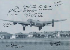 A Lancaster in low Flight, Black and White Photo, Signed by 9 including George Dunn, Colin Cole,