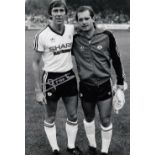 Football Autographed ARNOLD MUHREN 12 x 8 Photo : B/W, depicting Manchester United's Bryan Robson
