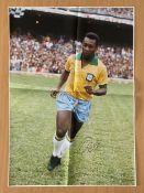 Pele signed 34x24 inch colour canvas pictured early on in his career playing for Brazil. Folded. All