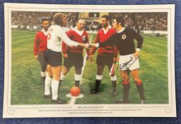 Football. Bobby Moncur Signed 18x12 colour photo. Photo shows Moncur(Scotland) shaking hands with