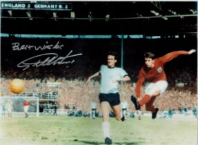 Geoff Hurst signed colour photo 16x12 Inch pictured scoring his Hat-trick Goal 1966 World Cup. All