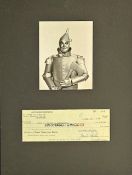 Jack Haley signed cheque mounted below black and white Tin man photo. Approx overall size 16x12inch.