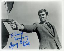 007 George Lazenby James Bond signed b/w 10 x 8 inch O.H.M.S.S. photograph. Scarce image with gun in