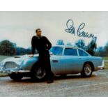 Sean Connery signed 10x8 inch colour pictured standing alongside Aston Martin. Good Condition. All