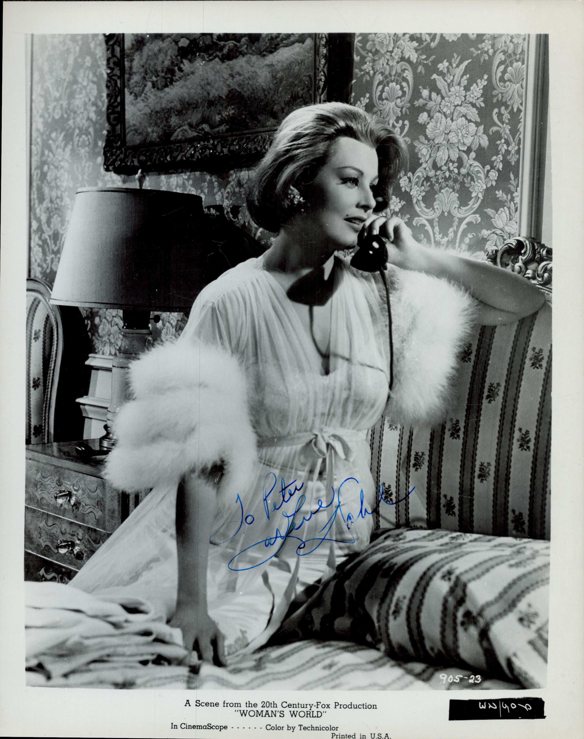 Arlene Dahl (1925-2021), actress. A vintage signed and dedicated 10x8 inch photo, seated on a bed in