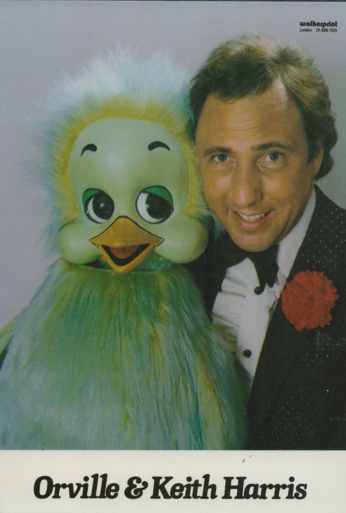 Keith Harris signed on back of Promo. Colour Photo. 6x4 Inch. Was an English ventriloquist, best