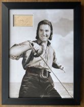 Errol Flynn signed card inset in black and white photo. Framed to approx size 20x14inch. (20 June