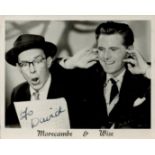 Morecambe and Wise signed 3x2inch black and white photo. Signed on dark part of image. Good