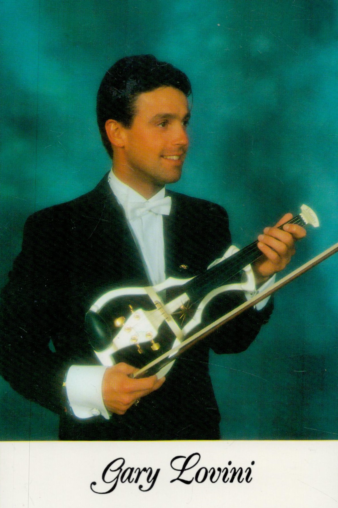 Gary Lovini signed on back of Colour Photo. 6x4 Inch. Violinist. Good condition. All autographs - Image 2 of 2
