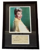Doris Day mounted Signed Cheque for $25.00 dated November 5th 1986 framed with colour photo, framed.