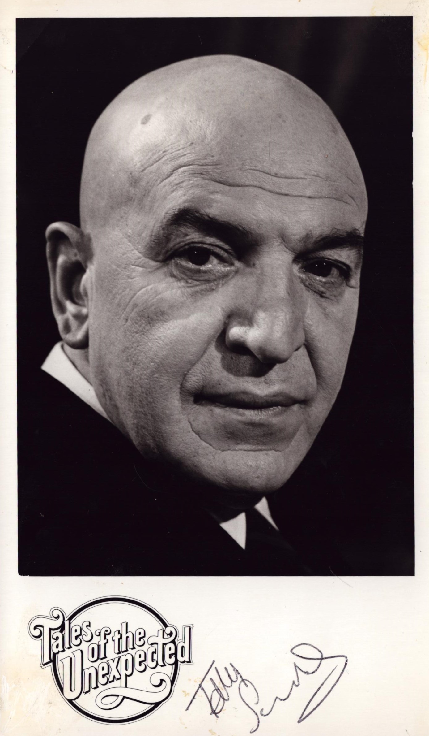 Telly Savalas signed 8x5 inch black and white Tales of the Unexpected promo photo. Good Condition.