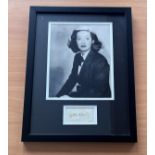 Bette Davis signed framed black and white photo with signature below.Measures 17"x13" appx. Good