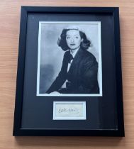 Bette Davis signed framed black and white photo with signature below.Measures 17"x13" appx. Good