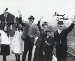 The Railway Children 8x10 B/W movie scene photo signed by the late Bernard Cribbins. Good Condition.