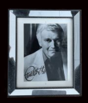 Charlton Heston secretarial signed black and white photo in mirrored frame 12x10 inch overall.