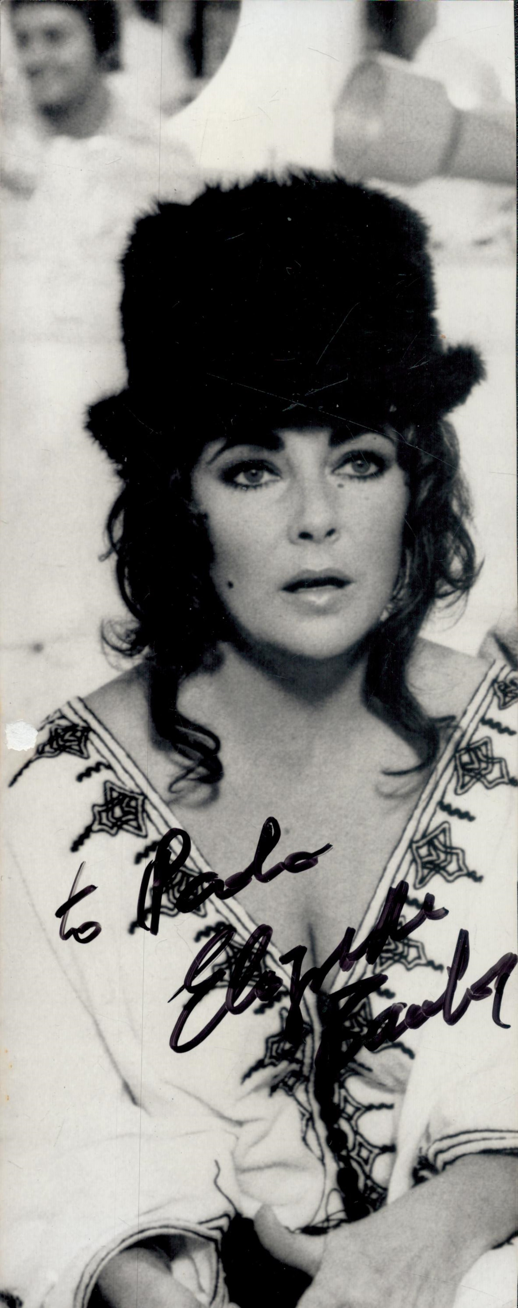 Elizabeth Taylor signed 10x4 black and white photograph dedicated and signed in black marker pen.