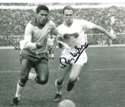 Ray Wilson signed 10x8 inch vintage black and white photo pictured in action for England against