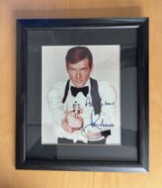 Roger Moore signed 15x13 inch overall framed and mounted James Bond colour photo. Good Condition.