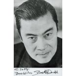 Burt Kwouk signed 5.5x3.5 inch black and white photo. Dedicated. Good Condition. All autographs come