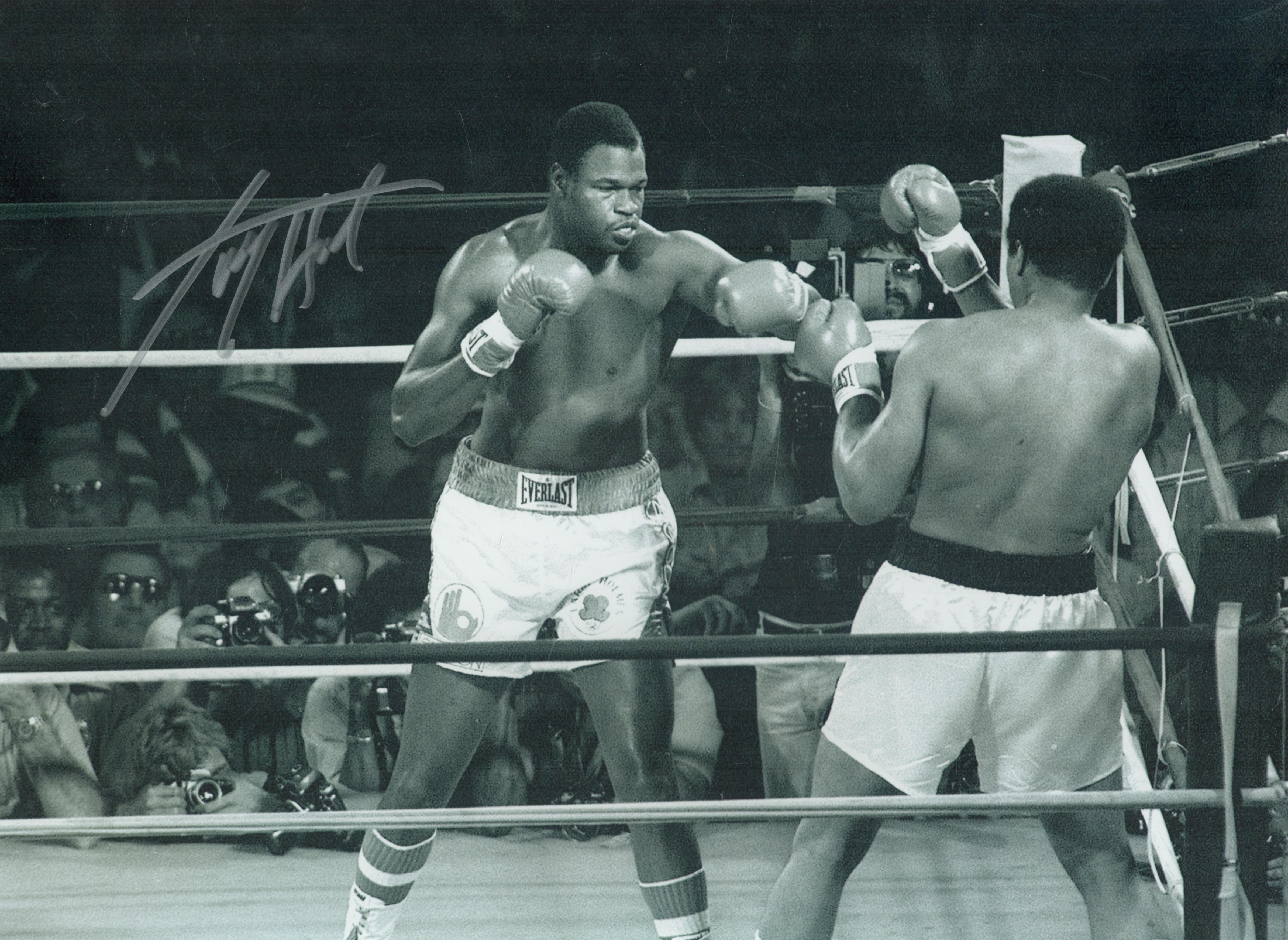 Larry Holmes signed 16x12 inch black and white photo pictured during his fight with Muhammad Ali.
