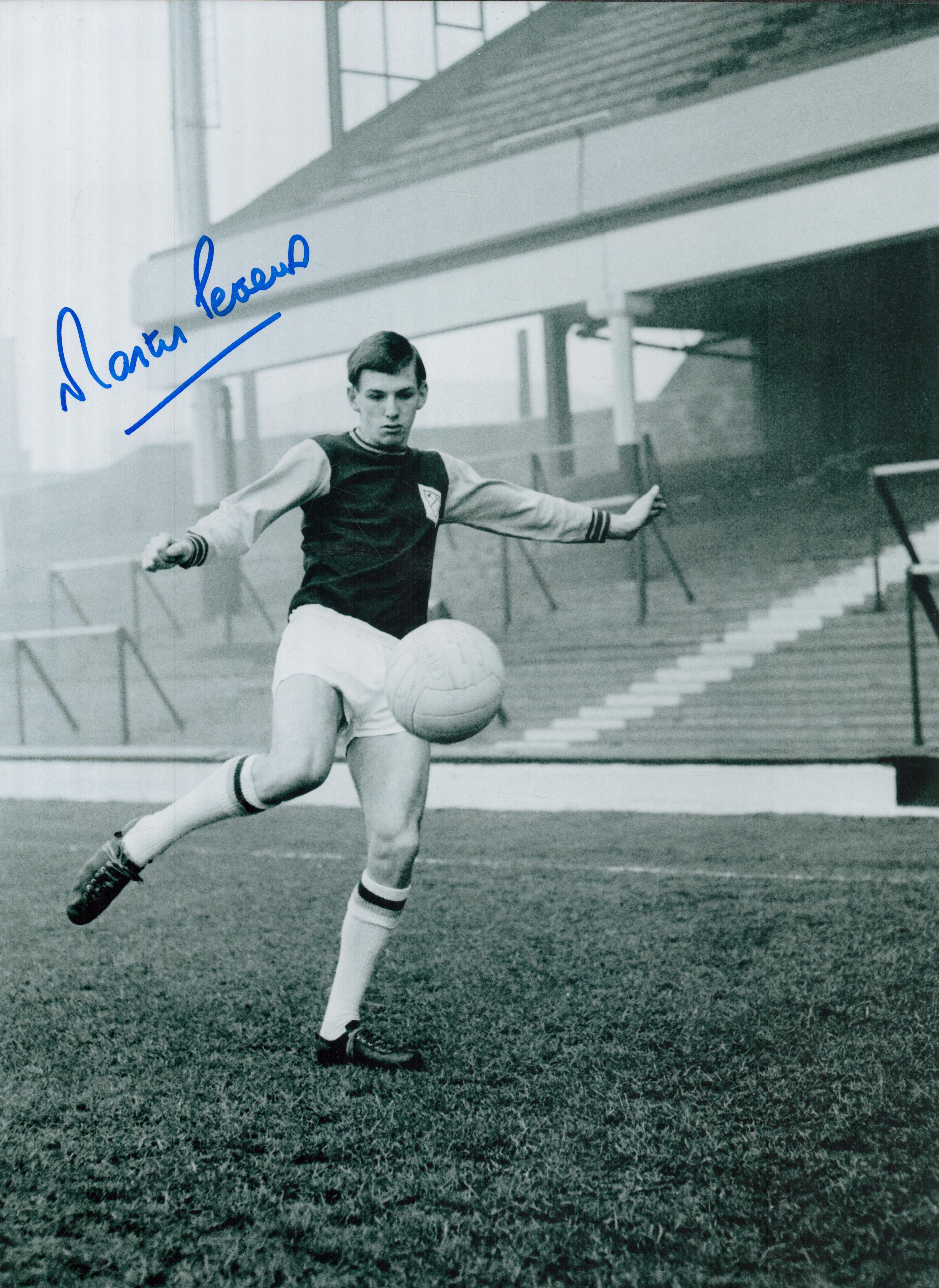 Martin Peters signed 16x12 inch black and white photo pictured during his playing days with West Ham
